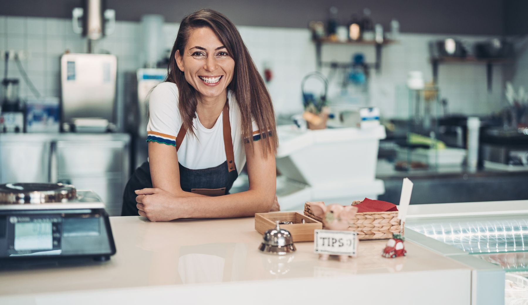 Happy woman business owner in her store